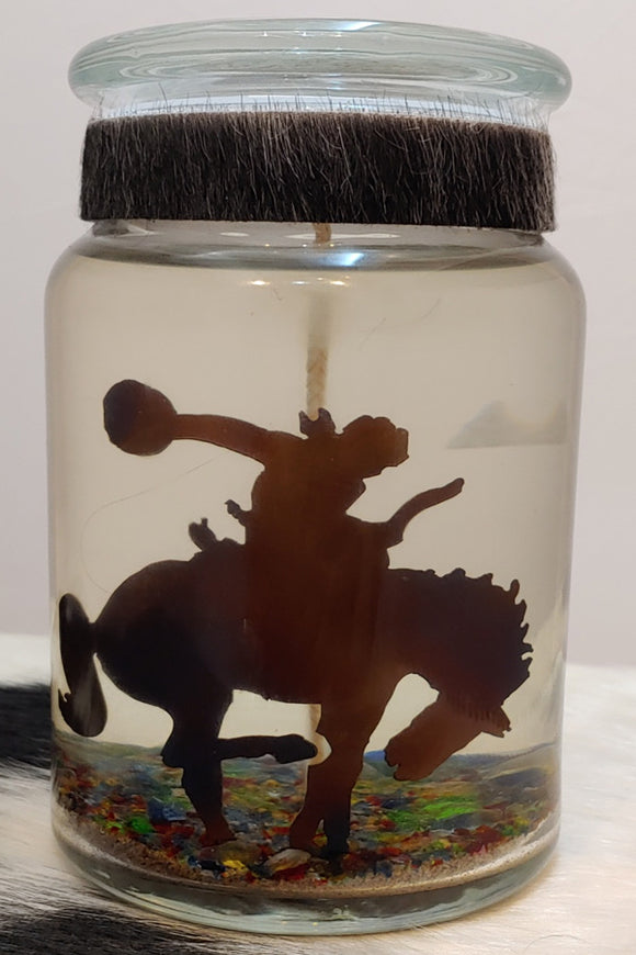 Busting bronc cowboy metal cutout in a candle