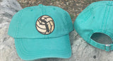 Seafoam green canvas baseball hat with a Smithson Valley volleyball leather patch closeup.