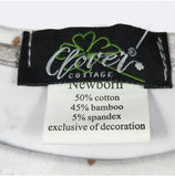 Clover Cottage label on a baby garment with fabric details