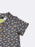 Children's polo shirt with tractor pattern on a light gray background