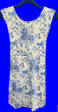 White dress with blue floral and bow pattern on a hanger