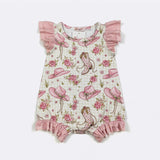 Baby romper with cowboy boot and hat pattern on a white background