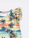 Tropical print shirt with palm trees and sunset design on a plain background