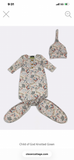 Baby knotted gown and hat set with floral pattern on a white background