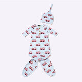 A baby three-piece outfit set featuring a long-sleeve footed sleeper, a matching bonnet, and footies, all in a light blue color with a repeating red fire truck pattern, laid out on a white background.