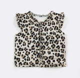 A sleeveless quilted puffer vest with a leopard print pattern, featuring ruffled trim along the collar and front placket, laid flat on a white background.
