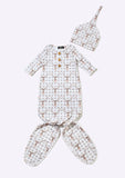 A baby sleepwear set featuring a long-sleeve footed sleeper with three front buttons, a matching pointed beanie hat, and a pair of booties, all in an off-white fabric with a brown and beige geometric lattice pattern.