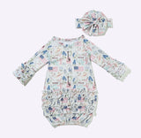 A baby long-sleeve romper and matching headband set with a Texas-themed print featuring flags, guitars, and the word 'TEXAS' on a white background.