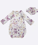 Baby romper with floral and butterfly pattern and matching hat on a white background