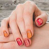 Close-up of a hand with colorful nail art on a wooden surface