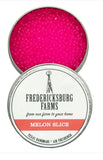 Fredericksburg Farms melon slice air freshener in a tin with pink contents.