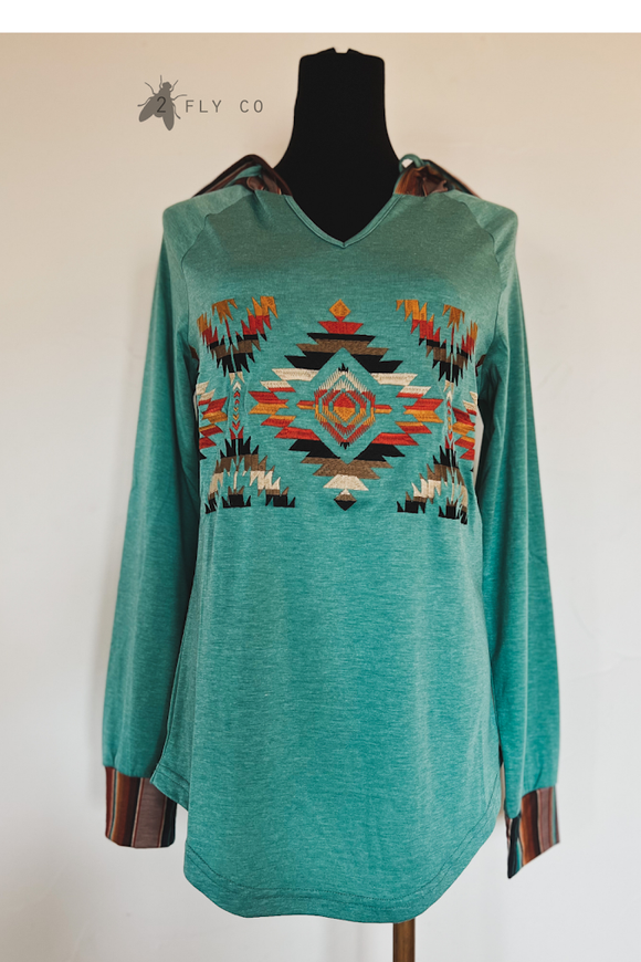 Long sleeved hoodies tshirt with embroidered chest. Serape wrist cuffs and serape hoodie front view.