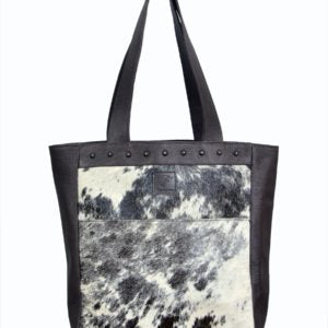 Cowhide tote with black straps and sides.