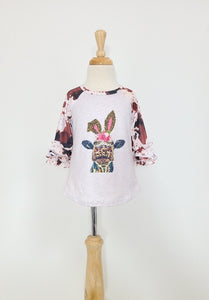 Toddler raglan sleeve with ruffles shirt. Cow wearing bunny ears and sleeves with cowhide print.