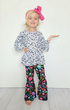 floral flare pants and a dalmatian print top with flare waist and sleeves. child's set on model