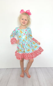 Candy canes and treats on an aqua colored girls dress with ruffles