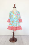 Candy canes and treats on an aqua colored girls dress with ruffles on mannequinn