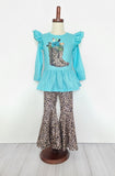 Turquoise ruffle long-sleeved top with animal print boots on chest. Pants match the animal print boots. Clover Cottage set