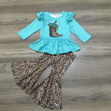 Turquoise ruffle long-sleeved top with animal print boots on chest. Flare pants match the animal print boots. Clover Cottage 