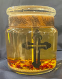 Cross - Medium gel candle with yellow gel and yellow and red rocks at the bottom 