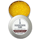 A small, round tin Fredericksburg Farms air freshener with a yellow solid color interior, labeled 'Butterly Vanilla'.