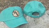 Seafoam green canvas baseball hat with a Smithson Valley volleyball leather patch.