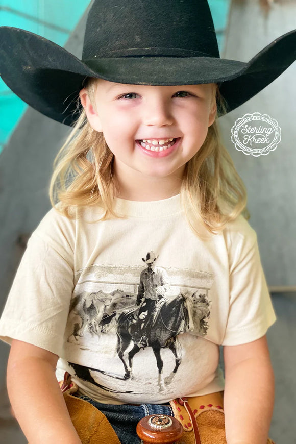 Child's working cowboy image t-shirt being worn by a child in a black cowboy hat. Sterling Kreek