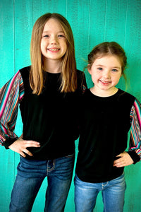 Two young tweens wearing the Sassy Sleeves Sterling Kreek top with jeans
