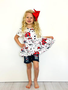 Young girl in red barn short set by clover cottage