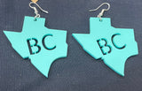 Texas-shaped turquoise acrylic earrings with the BC for Bracken Christian schools