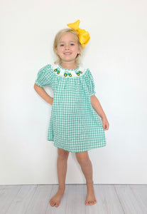 Green smocked short sleeved dress with tractors around the collar - on mannequinn
