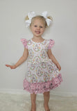Paisley ruffle print in pink and pink bunnies in a floral frame made the bodice of this Clove Cottage child's dress
