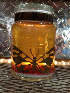 Large gel candle with metal butterfly cutout inset