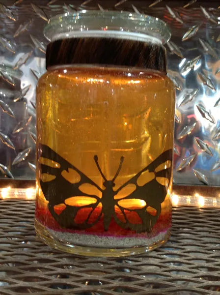 Large gel candle with metal butterfly cutout inset